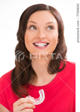 Closeup portrait of charming woman wearing orthodontic braces ho Closeup portrait of charming woman wearing orthodontic braces ho 7590600