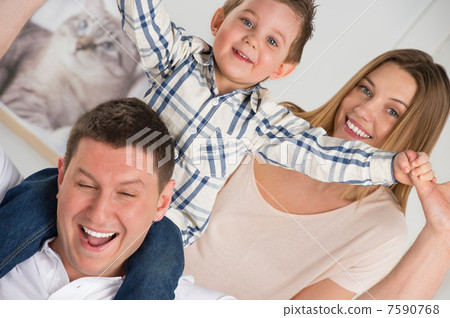 Beautiful happy family having fun at home 7590768