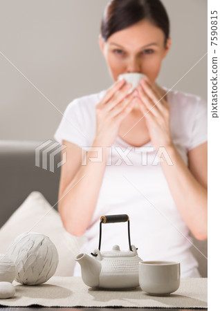 Detail shot of a tea set and thoughtful beautiful young woman si Detail shot of a tea set and thoughtful beautiful young woman si 7590815