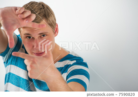 Portrait of smiling caucasian european young man making frame wi Portrait of smiling caucasian european young man making frame wi 7590820
