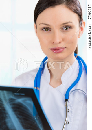 Female doctor looking at a lungs or torso xray, fluorography Female doctor looking at a lungs or torso xray, fluorography 7590915