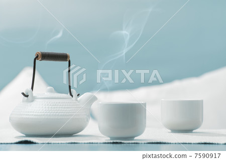 Teapot and cups on table at comfortable relaxation lounge Teapot and cups on table at comfortable relaxation lounge 7590917