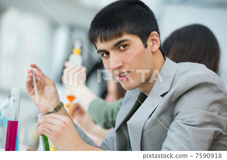High School students. Handsome mixed race guy working at laborat High School students. Handsome mixed race guy working at laborat 7590918