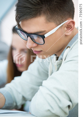 High School students. Young handsome man student sitting in clas High School students. Young handsome man student sitting in clas 7590975