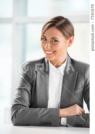 Closeup portrait of cute young business woman smiling at her off Closeup portrait of cute young business woman smiling at her off 7591079