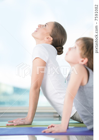 Mother and son doing exercise at home Mother and son doing exercise at home 7591082