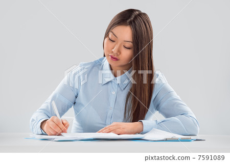 Closeup portrait of a cheerful young businesswoman doing paperwo Closeup portrait of a cheerful young businesswoman doing paperwo 7591089
