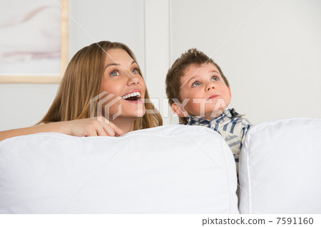 Happy young mother and her cute son playing at home and dreaming 7591160