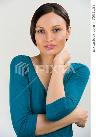 Portrait of a cute young woman standing with her hand folded aga Portrait of a cute young woman standing with her hand folded aga 7591182