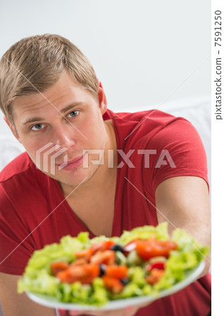 Young handsome man preparing to eat fresh healthy salad sitting Young handsome man preparing to eat fresh healthy salad sitting 7591250