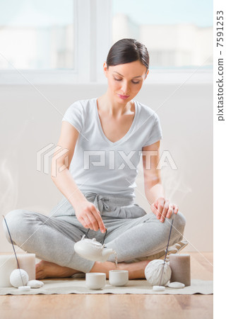 Young woman relaxing with tea and aromatherapy Young woman relaxing with tea and aromatherapy 7591253