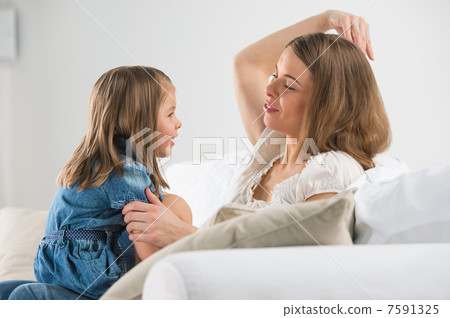 Portrait of adorable young girl and mother in a playful mood at Portrait of adorable young girl and mother in a playful mood at 7591325