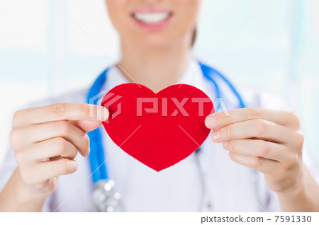 Female doctor with stethoscope holding red human heart at hospit Female doctor with stethoscope holding red human heart at hospit 7591330