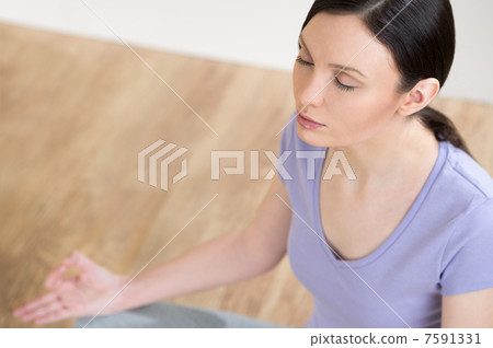 Portrait of pretty young woman doing yoga exercise on mat Portrait of pretty young woman doing yoga exercise on mat 7591331