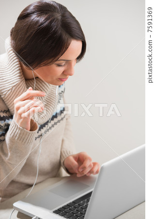 Portrait of a young woman with headphones, lying in front of her Portrait of a young woman with headphones, lying in front of her 7591369