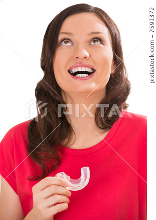 Closeup portrait of charming woman wearing orthodontic braces ho Closeup portrait of charming woman wearing orthodontic braces ho 7591372
