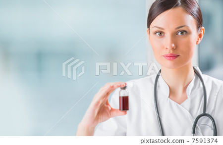 Portrait of pretty female laboratory assistant analyzing a blood Portrait of pretty female laboratory assistant analyzing a blood 7591374