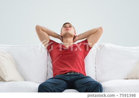 Portrait of a handsome young man looking upwards while relaxing Portrait of a handsome young man looking upwards while relaxing 7591398