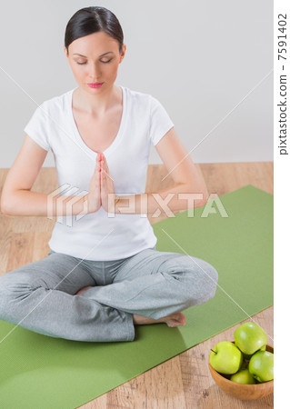 Portrait of beautiful young woman doing yoga exercise - Meditati Portrait of beautiful young woman doing yoga exercise - Meditati 7591402
