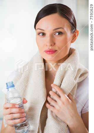Portrait of confident young woman in sportswear holding a water Portrait of confident young woman in sportswear holding a water 7591629