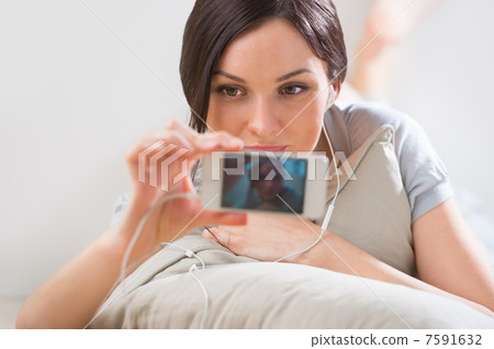 A young woman lying on the floor with her phone and shooting ( p A young woman lying on the floor with her phone and shooting ( p 7591632
