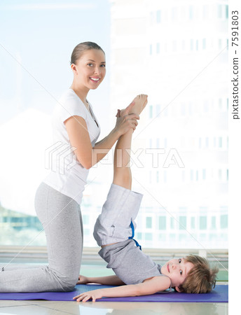 Healthy morning stretching - woman with son doing gymnastic exer Healthy morning stretching - woman with son doing gymnastic exer 7591803