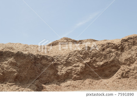 Mountain of sawdust and blue sky Mountain of sawdust and blue sky 7591890