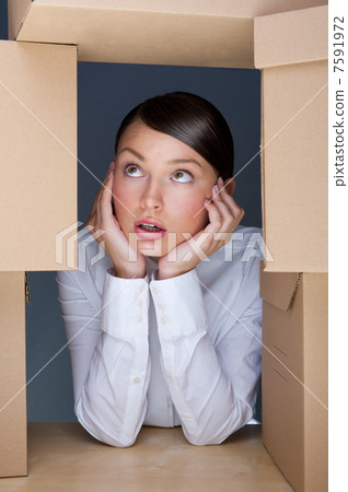 Portrait of young woman surrounded by lots of boxes. Lots of wor 7591972