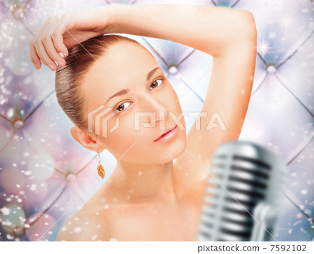 Portrait of a glamorous girl at stage singing and dancing Portrait of a glamorous girl at stage singing and dancing 7592102