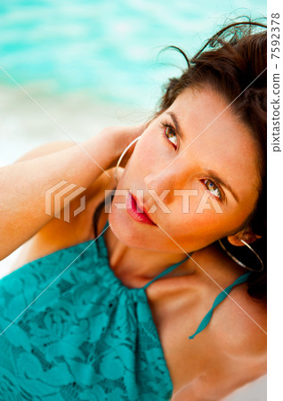 Pretty young woman with hot look and sexy smile sitting on beach Pretty young woman with hot look and sexy smile sitting on beach 7592378