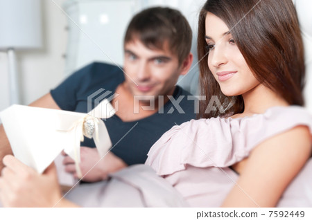 Closeup portrait of a happy young couple relaxing on the bed. Ma Closeup portrait of a happy young couple relaxing on the bed. Ma 7592449