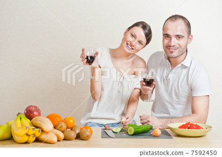 Young love couple cooking and drinking red whine from beautiful Young love couple cooking and drinking red whine from beautiful 7592450