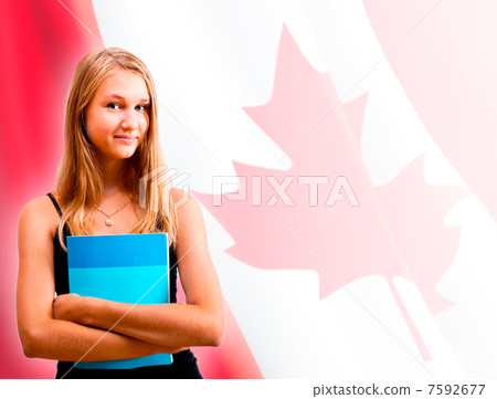 Portrait of pretty young woman holding book in her arms. Canadia 7592677