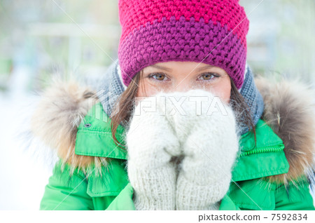 Winter woman in snow looking at camera outside on snowing cold w 7592834
