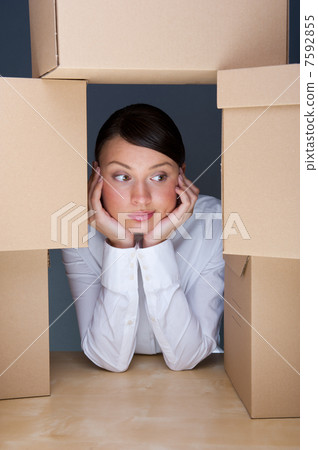 Portrait of young woman surrounded by lots of boxes. Lots of wor 7592855