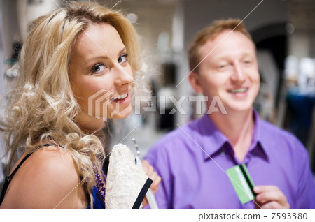 Young attractive happy couple shopping at mall. Young attractive happy couple shopping at mall. 7593380