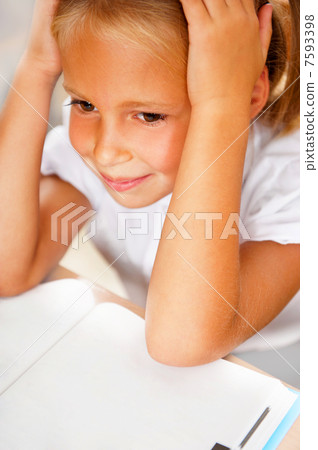 Image of smart child reading interesting book in classroom Image of smart child reading interesting book in classroom 7593398