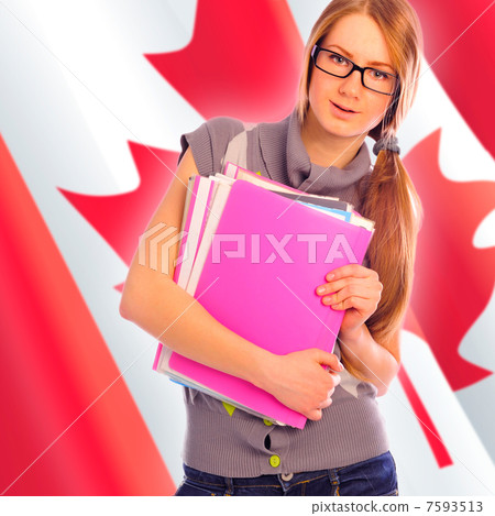 Portrait of pretty young woman holding book in her arms. Canadia 7593513