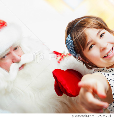 Christmas theme: Santa Claus and little girl having a fun. Indoo Christmas theme: Santa Claus and little girl having a fun. Indoo 7593701