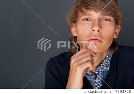Portrait of young man with smart and wise look. Looking at camer 7593708