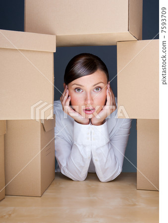 Portrait of young woman surrounded by lots of boxes. Lots of wor 7593709