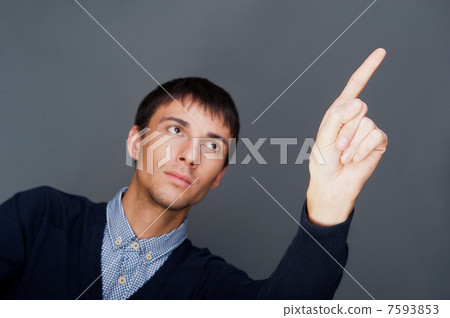 Young business man pressing a touchscreen button while working a 7593853