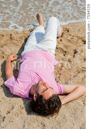 Portrait of attractive and happy man on the beach relaxing and d 7594539