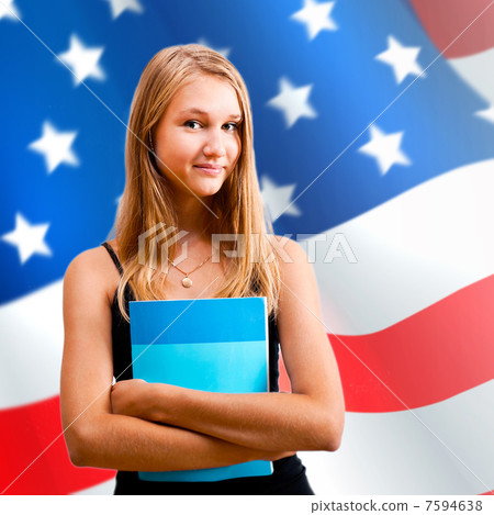 Portrait of pretty young woman holding book in her arms. USA Fla 7594638
