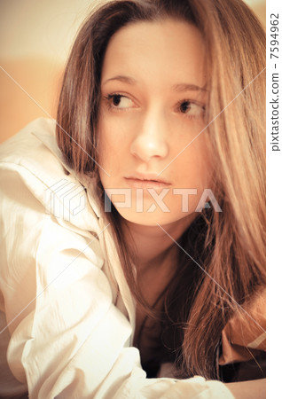 Closeup portrait of young pretty girl laying on her bed Closeup portrait of young pretty girl laying on her bed 7594962