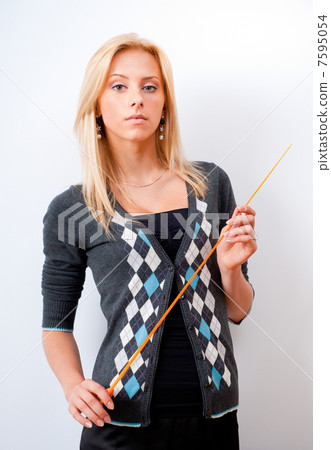 Portrait of young teacher pointing on white marker board in mode 7595054