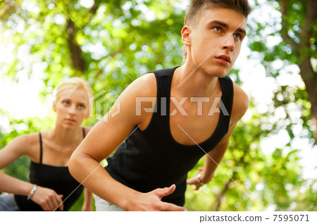 Closeup Portrait of Young Couple Jogging In Park Closeup Portrait of Young Couple Jogging In Park 7595071