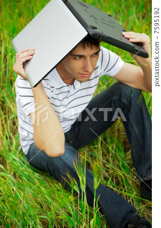 A smiling man with laptop outdoor A smiling man with laptop outdoor 7595192