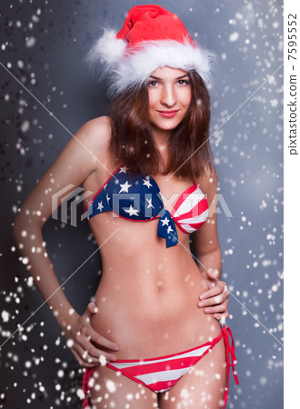 20-25 years old beautiful woman in christmas hat and swimsuit wi 20-25 years old beautiful woman in christmas hat and swimsuit wi 7595552