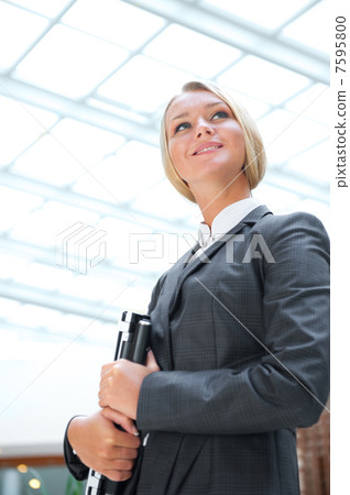 Portrait of a cute business woman with her laptop inside office Portrait of a cute business woman with her laptop inside office 7595800